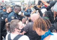  ?? BEN GRAY ATLANTA JOURNAL CONSTITUTI­ON ?? Protesters and police clash around the CNN Center in Atlanta.