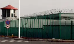  ?? AP ?? A guard tower and barbed wire fences are seen around a section of the Artux City Vocational Skills Education Training Service Centre.