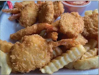  ?? (Arkansas Democrat-Gazette/Eric E. Harrison) ?? The folks inside the Red River Catering Co. food truck cooked the 12 pieces of our butterfly shrimp basket to order.