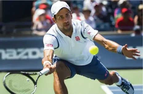  ?? NATHAN DENETTE/THE CANADIAN PRESS ?? Novak Djokovic deftly reaches to return to Gilles Muller of Luxembourg during second-round Rogers Cup play on Wednesday.