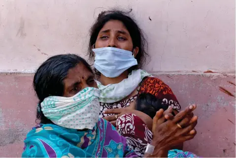  ??  ?? Women outside a mortuary to receive the body of a relative who died after the gas leak at the LG Polymers plant in Visakhapat­nam on May 8