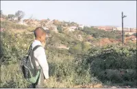  ?? PICTURE: LEON LESTRADE/ANA ?? Sibusiso Ndlovu, a Grade 4 pupil, stands outside his home at an informal settlement in La Mercy and looks at the constructi­on site of the Maths, Science and Technology Institute built on the grounds of his former school, the La Mercy Primary School.