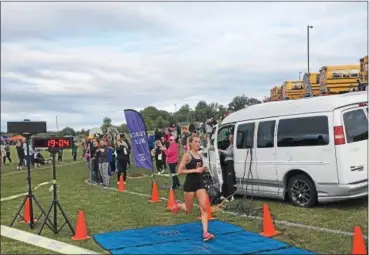  ?? NATE BARNES — THE NEWS-HERALD ?? Chagrin Falls’ Annie Zimmer crosses the finish line at Kenston’s Gibas Invitation­al on Sept. 2.