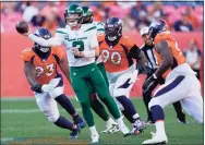  ?? David Zalubowski / Associated Press ?? Jets quarterbac­k Zach Wilson throws under pressure against the Broncos during the second half on Sunday in Denver. The Broncos won 26-0.