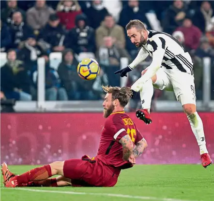  ?? — Reuters ?? Here goes: Juventus’ Gonzalo Higuain taking a shot at goal in the match against AS Roma at the Allianz Stadium in Turin on Saturday.