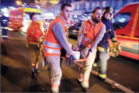  ?? (File Photo/AP/Thibault Camus) ?? A woman is evacuated from the Bataclan concert hall Nov. 13, 2015, after a shooting in Paris.