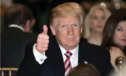  ??  ?? Donald Trump gives a thumbs-up as he has Thanksgivi­ng Day dinner at Mar-a-Lago. Photograph: Susan Walsh/AP