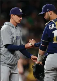  ??  ?? Milwaukee Brewers Manager Craig Counsell (left) will have several intrasquad scrimmages as the Brewers try to simulate the intensity of a real game in the lead up to the regular season. (AP/David Zalubowski)