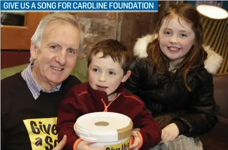  ??  ?? Tony Penston and his grandchild­ren Tomás and Caoimhe O’Neill at the Give us a Song for the Caroline Foundation event at the Hotspot in Greystones.