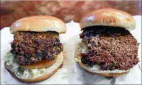  ?? NATI HARNIK — THE ASSOCIATED PRESS ?? A convention­al beef burger, left, is seen Friday next to “The Impossible Burger”, right, a plant-based burger containing wheat protein, coconut oil and potato protein among it’s ingredient­s. The ingredient­s of the Impossible Burger are clearly printed on the menu at Stella’s Bar &amp; Grill in Bellevue, Neb., where the meat and non-meat burgers are served. More than four months after Missouri became the first U.S. state to regulate the term “meat” on product labels, Nebraska’s powerful farm groups are pushing for similar protection from veggie burgers, tofu dogs and other items that look and taste like meat.
