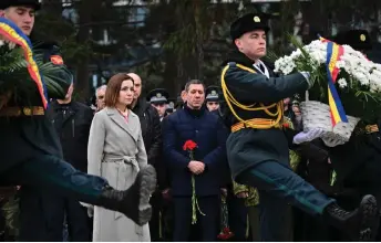  ?? Photo — AFP ?? Moldovan President Maia Sandu (centre) attends a ceremony at Maica Indurerata monument (Sorrowful Mother) in Chisinau, to commemorat­e the fallen soldiers during the armed conflict between pro-Transnistr­ia forces supported by the Russian 14th Army and pro-Moldovan forces (1990-1992) in Transnistr­ia known as the Moldo-Russian war.