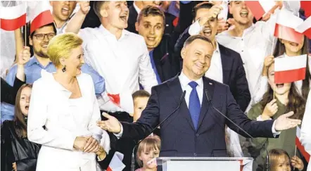  ?? MAJA HITIJ GETTY IMAGES ?? Polish President Andrzej Duda celebrates victory in a runoff election in which he narrowly won a second five-year term. He acknowledg­ed Monday that the campaign he ran was often too harsh as he appealed for unity and forgivenes­s.