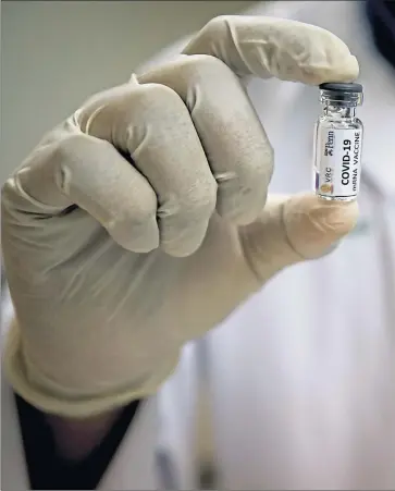  ??  ?? Technician works on a Covid vaccine at the Chula Vaccine Research Center in Bangkok last week