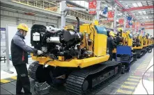  ?? CHEN WEI / FOR CHINA DAILY ?? Workers assemble excavators at Liugong Changzhou Machinery Co in Changzhou, Jiangsu province.