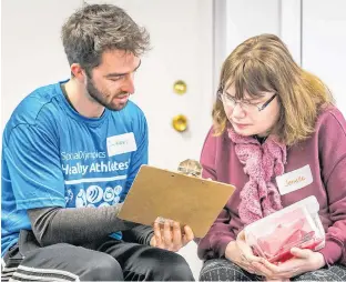  ?? SPECIAL OLYMPICS P.E.I. PHOTO ?? Mental performanc­e coach Jackson Slauenwhit­e reviews strategies with Special Olympics P.E.I. athlete Janelle Dawson.