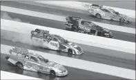  ?? By Jared C. Tilton, US Presswire ?? Spread out: From left, John Force, Ron Capps, Dale Creasy Jr. and Jim Head drive four-wide at zmax Dragway on April 17, 2011.