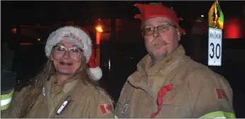  ??  ?? Candida and Marvin Spackman, representi­ng the Walsh and Irvine volunteer fire department­s helped their Seven Persons colleagues spread Christmas cheer and collect food items for the Medicine Hat and District Food Bank. Their son, Brandon ( not pictured) also participat­ed, representi­ng the Box Springs volunteer fire department.