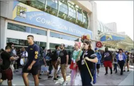  ?? PHOTO BY AL POWERS — INVISION — AP, FILE ?? In this Thursday file photo, guests attend the first day of Comic-Con Internatio­nal in San Diego. More than 130,000 pop culture devotees are descending on San Diego’s Gaslamp District, Wednesday for the annual four-day comic book convention ComicCon. And without Marvel Studios, HBO and Star Wars at the convention, other brands have a unique opportunit­y to pop.