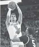  ?? KEN RUINARD/USA TODAY SPORTS ?? Clemson’s Joseph Girard III takes a shot near Pitt’s Ishmael Leggett (5) on Tuesday at Littlejohn Coliseum.