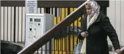  ?? ANDREW FRANCIS WALLACE/TORONTO STAR ?? Ayanle Ali’s mother leaves the courthouse after her son’s hearing was reschedule­d.