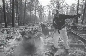  ?? MARCUS YAM/LOS ANGELES TIMES ?? A search and rescue team comb through debris for human remains Nov. 20 after the Camp Fire destroyed most of Paradise.