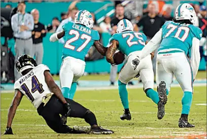  ?? WILFREDO LEE / AP ?? Dolphins cornerback Xavien Howard (25) runs for a touchdown after recovering a fumble by Ravens wide receiver Sammy Watkins (14) during the second half Thursday in Miami Gardens, Fla.