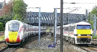  ?? DAVID RICE ?? Two generation­s of East Coast traction pass at York on October 16, as No. 801202 (left), heads away south with the 1E09/09.30 Edinburgh to King’s Cross, while No. 91119 Bounds Green Intercity Depot arrives with the 1N11/09.06 from King’s Cross.