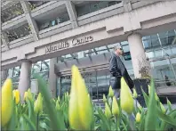  ?? CP FILE PHOTO ?? A man walks by the Manulife Centre in Toronto on the day of the 2012 Manulife Financial annual general meeting.