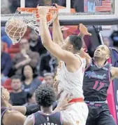  ?? LYNNE SLADKY/AP ?? Hawks forward Omari Spellman dunks over Rodney McGruder during the Heat’s 115-113 loss on Tuesday night.