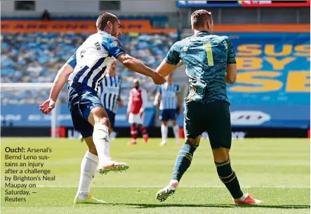  ?? — Reuters ?? Ouch!: arsenal’s Bernd Leno sustains an injury after a challenge by Brighton’s neal Maupay on saturday.