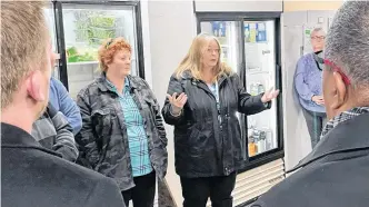  ?? ?? Susan Wright, who became a volunteer with the Matthew 25 Windsor and District Food Bank about four years ago, told Nova Scotia politician­s visiting the facility on Jan. 31 that most people don’t realize how much behind the scenes work goes into providing clients with meals. Listening to the discussion is fellow volunteer Sylvia Jee, on the left.