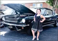  ?? PHOTOS BY JESI YOST — MEDIANEWS GROUP ?? Maya Ziegler, 6, of Boyertown pictured here with a 1965 Ford Mustang, loves to attend car shows with her Papa Mark. Boyertown’s Cruise Night was the second car show she visited.