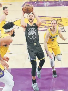  ??  ?? Golden State Warriors guard Stephen Curry drives to the basket past Los Angeles Lakers guard Alex Caruso (right) and in the first half of the game at Staples Center, in this April 4 file photo. — USA TODAY Sports photo