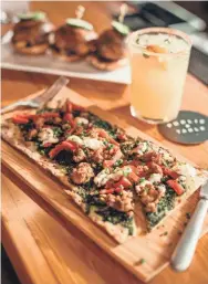  ?? CHINO VILLATORO ?? Public Table in West Allis will serve chorizo and goat cheese flatbread and beef sliders, among other menu items.