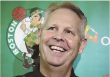  ?? STAFF PHOTO BY JOHN WILCOX ?? REASON TO SMILE: Celtics president Danny Ainge reflects yesterday on a busy start to the offseason, which included the signing of Gordon Hayward.