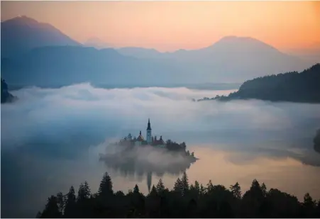  ?? ?? Church in hazy Lake Bled, Slovenia