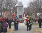  ?? ?? The flag party prepares to leave the cenotaph at the end of the outdoor Remembranc­e Day service in Swift Current.