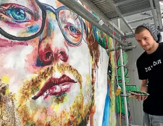  ?? PHOTO: HAMISH MCNEILLY/STUFF ?? Artist Tyler Kennedy Stent working on his Ed Sheeran mural in Dunedin.