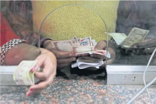  ??  ?? TIGHT ON MONEY: The ban on 500 and 1,000 rupee banknotes has sent the economy that relies heavily on cash for consumer transactio­ns into chaos.