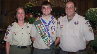  ?? ?? Longswamp Eagle Scout Caleb Moyer with his parents, Louise and Brian Moyer during his Eagle Scout ceremony on Sept. 24.