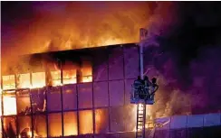  ?? ?? Above, rescuers work to extinguish fire at the burning Crocus City Hall concert venue.