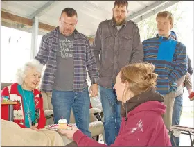  ?? (NWA Democrat-Gazette/Janelle Jessen) ?? Mary Fields (left), who will turn 91 in a few weeks, smiles Saturday as Pastor Wayne Thomas (second from left) of Kind at Heart Ministries, Stacey Conrad and Erik Eliason help a crowd of volunteers sing happy birthday, and Allison Bellomy of Kind at Heart, presents her with a cupcake. Kind at Heart Ministries partnered with Upward Fitness for a day of service.