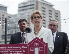  ?? CHRISTOPHE­R KATSAROV, THE CANADIAN PRESS ?? Ontario Finance Minister Charles Sousa, left, Premier Kathleen Wynne and Housing Minister Chris Ballard announce measures to cool southern Ontario’s housing market.