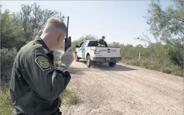  ?? Brian van der Brug Los Angeles Times ?? BORDER PATROL Agent Dave Thomas monitors radio traffic as colleagues search heavy brush for migrants identified earlier in the day by airborne surveillan­ce after they crossed the Rio Grande in Fronton, Texas.