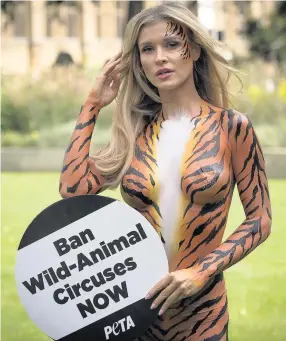  ??  ?? BARE ESSENTIALS Joanna protested in tiger body paint to call for circus animal ban