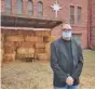  ?? AP PHOTO/STEPHEN GROVES ?? Rev. Tim Thies poses in front of the empty Nativity stable at Canton Lutheran Church in Canton, S.D.