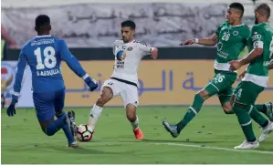  ?? KT file ?? Al Jazira’s Mbark Boussoufa vies for the ball against Al Shabab’s goalkeeper Salem Abdulla (left) and defender Hassan Ibrahim, Mohammad Juma during an Arabian Gulf League match. —