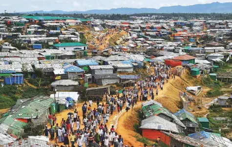  ?? AFP ?? Rohingya refugees stage a protest march after attending a ceremony marking the first anniversar­y of a military crackdown that prompted a massive exodus of people from Myanmar to Bangladesh, at the Kutupalong refugee camp in Ukhia.