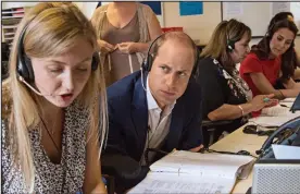  ??  ?? Sympathy: Prince William listens in to a parent’s call to YoungMinds