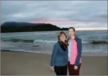  ?? SEAN MCDERMOTT VIA AP ?? This photo shows Associated Press reporter Jennifer McDermott, right, and her mother, Suzanne Grogan standing by Hanalei Bay in Kauai at sunset. Grogan traveled to Hawaii to celebrate her retirement from the hotel industry with her family.